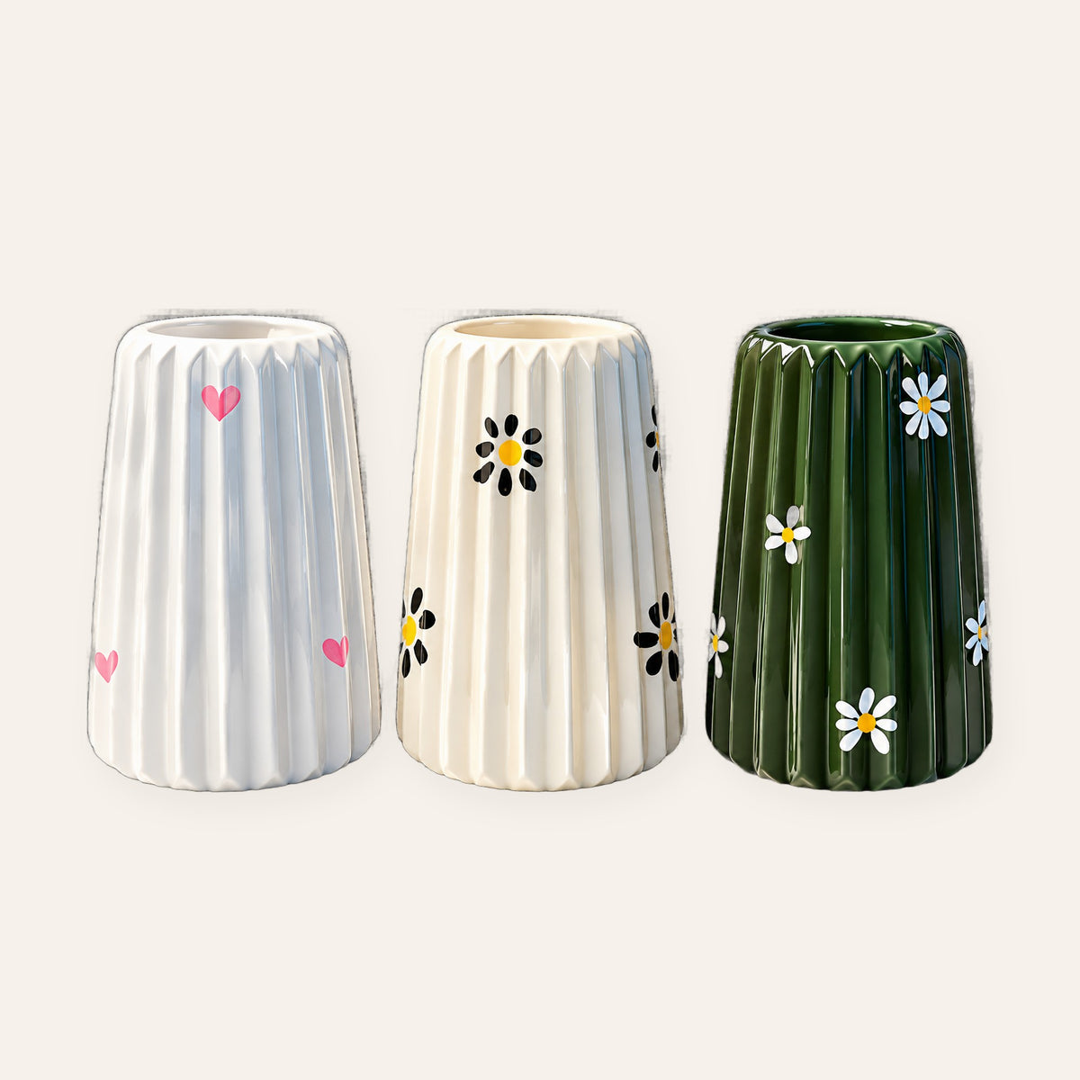 Painted fluted vases with pink hearts, black daisies and green daisies