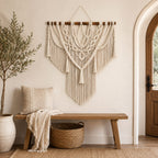 Macramé wall hanging above a wooden entryway bench