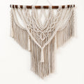 Macramé wall hanging styled in a boho living room